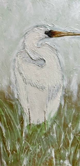 A white bird with an elongated neck stands in a blurred natural setting, surrounded by soft grass tones.