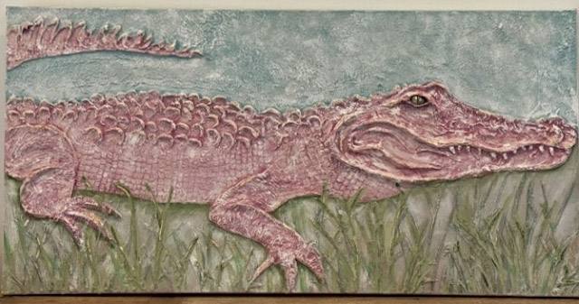 A textured artwork depicting a crocodile resting in grass, featuring intricate details and a serene background.